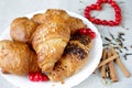 Croissants, spice, berries, in a plate and heart Royalty Free Stock Photo