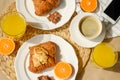 Coffee with croissants, pieces of chocolate, orange juice and tangerines for breakfast Royalty Free Stock Photo