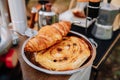 Croissants on stainless steel plate for camping. French tasty picnic. Strawberry pile. Summer Camping