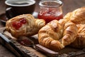 Croissants with strawberry preserves and cup of coffee