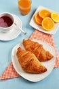 Croissants with tea and orange juice for breakfast Royalty Free Stock Photo