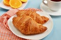 Croissants with tea and orange juice for breakfast Royalty Free Stock Photo