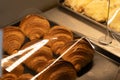 Croissants on a tray inside a transparent container box