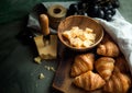 Croissants whit delicious cheese and grapes for tasty breakfast. Original tasty French croissants with cheese and on the Royalty Free Stock Photo