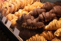 Croissants in the window. Different types of croissants. Chocolate croissants in a bakery