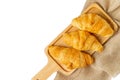 Croissants on wooden bread cutting board with sackcloth over white background. Croissant french breakfast with clipping path Top v Royalty Free Stock Photo