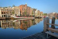 Crooked and colorful heritage buildings and houseboats, overlooking Amstel river with perfect reflections, Amsterdam Royalty Free Stock Photo