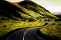 crooked empty road beyond horizont surrounded by green fells