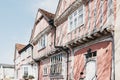 Crooked half-timbered pastel pink medieval houses in Lavenham, Suffolk, UK