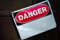 Crooked old metal warning sign that reads DANGER. Copy space. Royalty Free Stock Photo