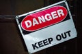 Crooked old metal warning sign that reads DANGER KEEP OUT. Copy space. Royalty Free Stock Photo