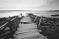 Crooked old wooden dock on the rocky shore. Russia, Karelia