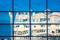 Crooked reflection of houses in a glass window