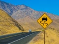 Curved ahead warning sign on highway road