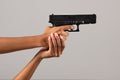 Female black hands with gun Royalty Free Stock Photo