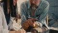 Crop archaeologist measuring golden necklace