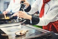 Crop of chef seasoning fish with pepper in the kitchen Royalty Free Stock Photo