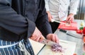 Crop of chefs cutting onions and other food ingredients Royalty Free Stock Photo