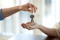 Close up of realtor give keys to female buyer