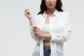 Stylish woman in white shirt and jeans confidently looking at camera