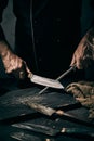 Crop cook sharpening knife in kitchen