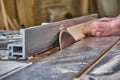 Crop craftsman cutting wood with table saw Royalty Free Stock Photo