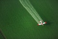 An overhead view of a crop duster spraying green farmland Royalty Free Stock Photo