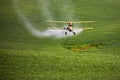 Crop Duster spraying a farm field. Royalty Free Stock Photo