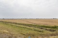 Water ditches irrigation system and a harvested grain field Royalty Free Stock Photo