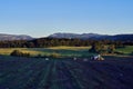 Crop field on a farm and a mountain on a clear sky Royalty Free Stock Photo