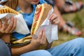 Crop girl eating sandwich in park