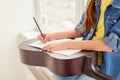 Crop girl making notes during guitar lesson Royalty Free Stock Photo