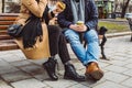 crop image. couple sitting on bench eating fast food drinking tea