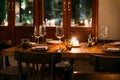 Crop image of romantic fine dining table with cutleries, plates, wine glasses, napkins and naperies on the table.