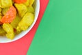 The crop image of turmeric chicken over red and green background