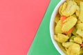 The crop image of turmeric chicken over red and green background