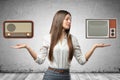 Crop image of young beautiful businesswoman, hands at sides, palms facing up, levitating retro radio set and outdated TV