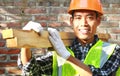 Crop images of man worker carrying wood smiling Royalty Free Stock Photo