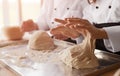 Crop kids kneading dough in bakery Royalty Free Stock Photo