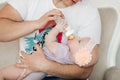 Crop of little cute baby lying on father`s hand and eating. Royalty Free Stock Photo
