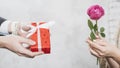 crop man giving gift woman with rose. High quality photo Royalty Free Stock Photo