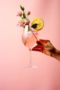 Crop person decorating mocktail with petal