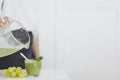 crop person pouring green smoothie glass. High quality photo
