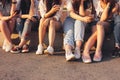 Crop photo of group of young happy tan girls real friends using mobile on sunset background