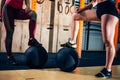 Crop photo of two woman put feet on medicine balls in gym Royalty Free Stock Photo