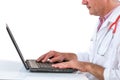 Crop profile view of a Smiling doctor working on laptop at his desk. on white Royalty Free Stock Photo