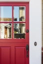 Crop of red front door with reflection Royalty Free Stock Photo