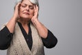 Elderly woman rubbing temples