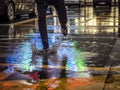 Crop man stepping in puddle on street Royalty Free Stock Photo