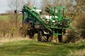 Crop sprayer parked and folded up in field